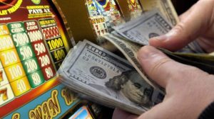 Casino Slot Machines, Hands Counting Bills of Cash