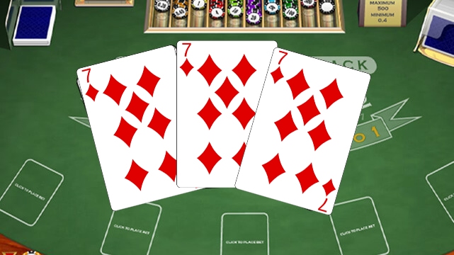 Three Seven of Diamonds on a Blackjack Table