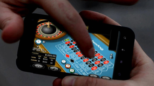 Hands Holding Phone Playing Online Roulette