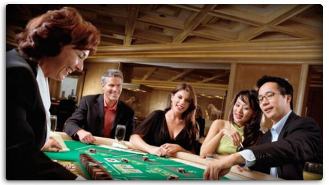 Dealer And Four Players Enjoying Baccarat As Entertainment 