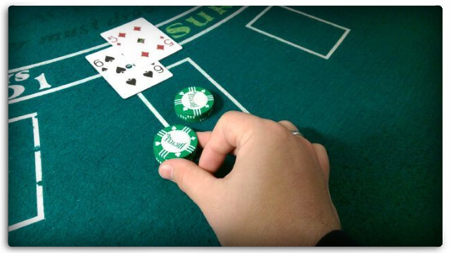 Blackjack Table and a Hand Placing a Bet