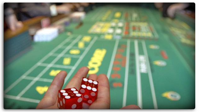 Craps Table Hand Rolling Dice