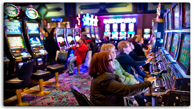 Older Women Gambling At Slot Machines With Uneasy Looks On Their Face