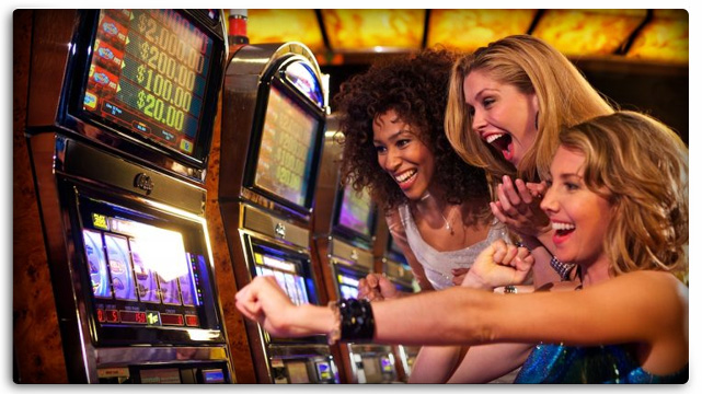 Three Excited Women Gambling Together On Slot Machine